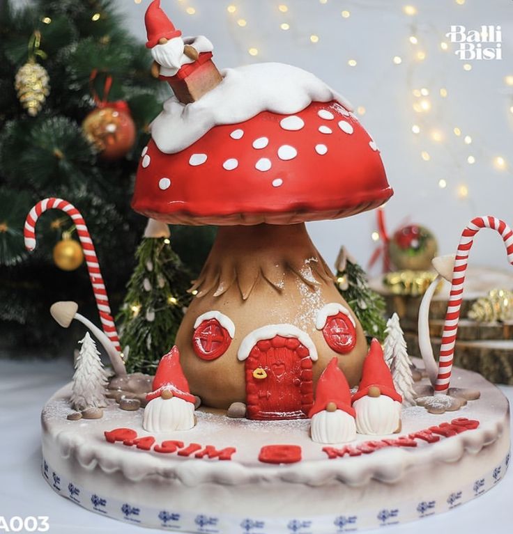 there is a cake that looks like a mushroom house with santa claus on top and candy canes in the bottom