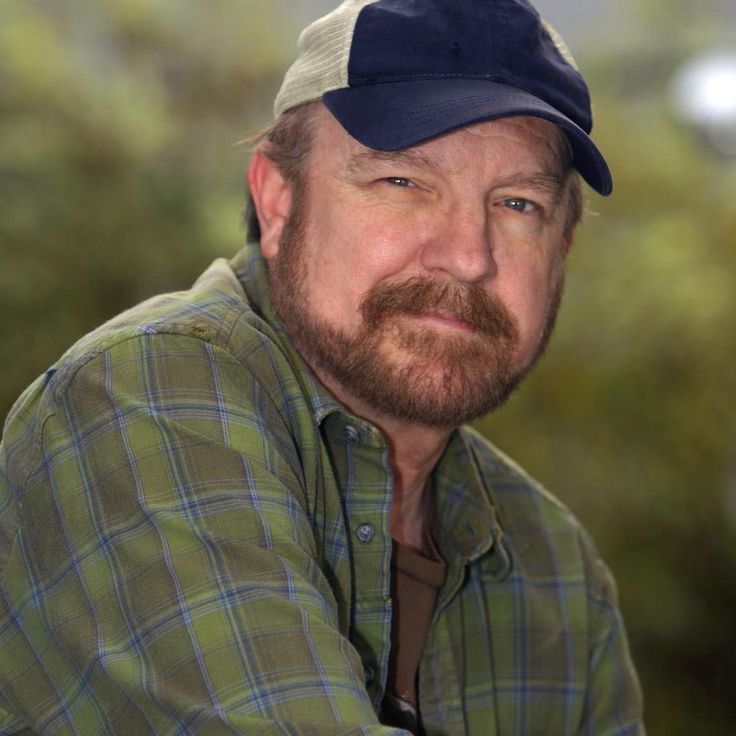 a man with a beard wearing a hat