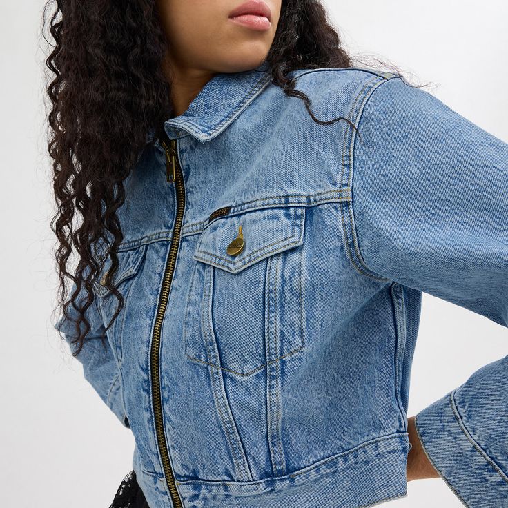 A classic trucker style is updated with a zip-front cropped silhouette. Detailed with our Signature under the collar this boxy-fit denim jacket is crafted of organic cotton made without the use of harmful chemical fertilizers and pesticides. It’s finished with chest pockets a Coach flag and a leather patch at the back hem. | Coach Denim Crop Jacket In Organic Cotton - Women's Size XL - Blue Cropped Denim Jacket Outfit, Denim Crop Jacket, Coach Denim, Fitted Denim Jacket, Denim Jacket Outfit, Cropped Denim Jacket, Pesticides, Cropped Denim, Leather Patches