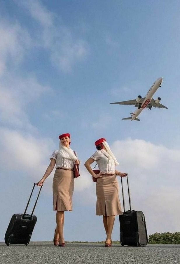 two women with suitcases and an airplane in the sky behind them on a runway