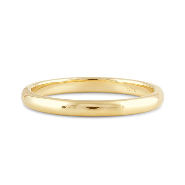 a yellow gold wedding ring with a thin band on the outside, and a plain surface