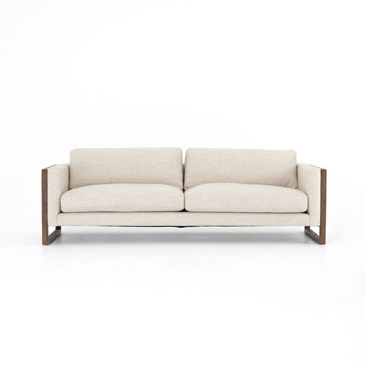 a white couch sitting on top of a wooden frame