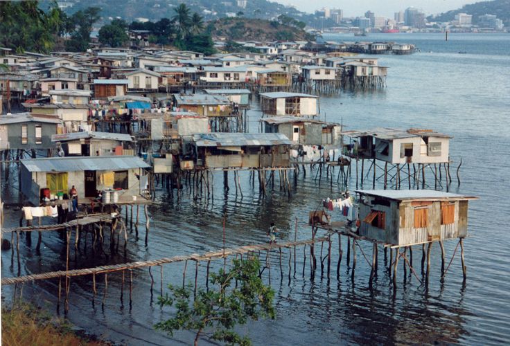 a group of shacks sitting on top of a body of water