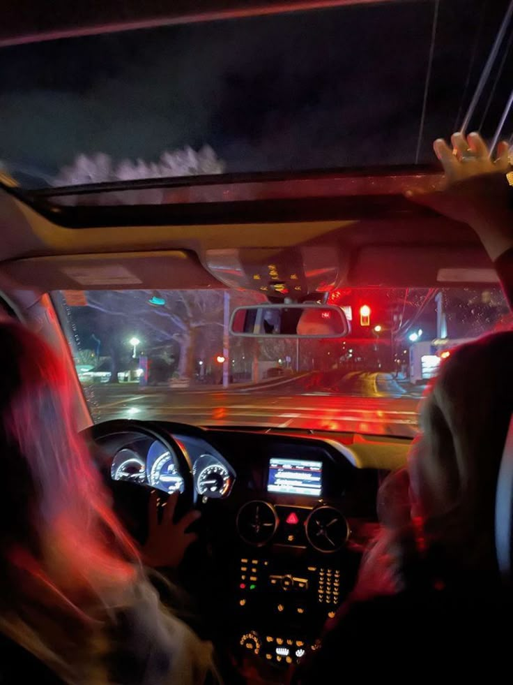 two people driving in a car at night