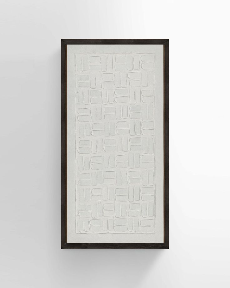 a white and black framed artwork hanging on the wall