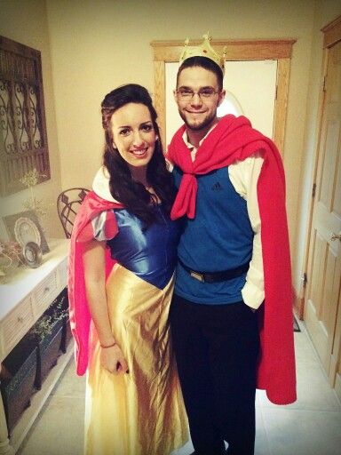 a man and woman dressed as snow white and prince charmingly pose for a photo