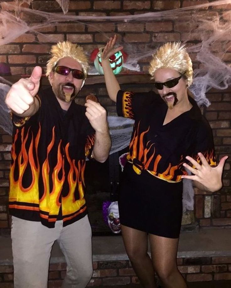 two people dressed in costumes standing next to each other and giving thumbs up with their hands