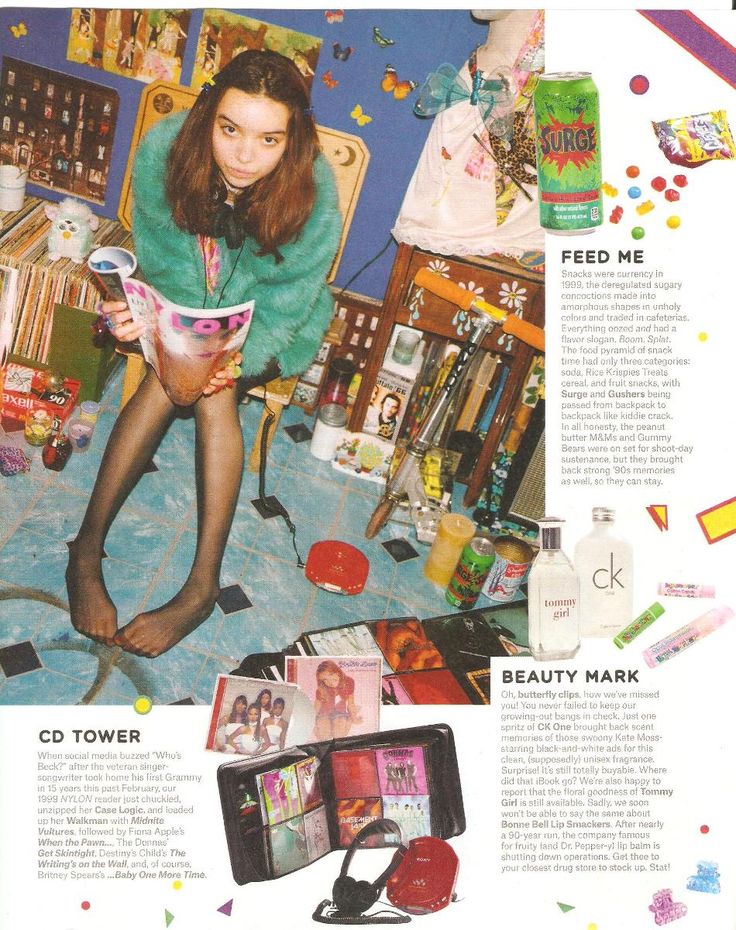 a woman sitting on top of a chair in front of a pile of books and magazines