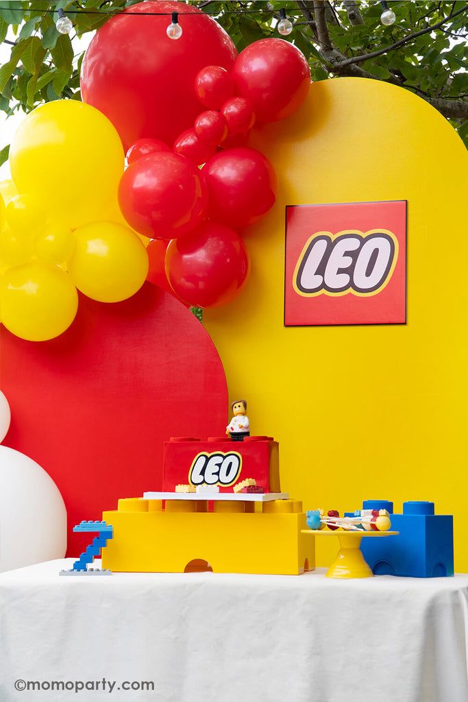 a table with balloons and legos on it in front of a sign that says leo