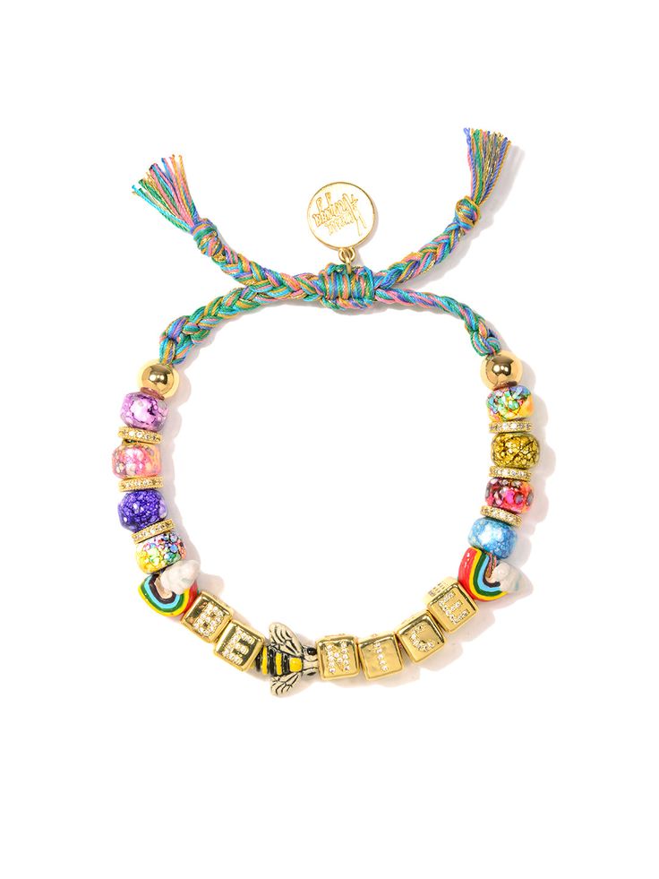 This Be Nice Bracelet is more than just a fashion statement - it's an attitude adjustment! Bright rainbow tie dye threadwork and glass charms shimmer in the light, while pave rhinestone accents and ceramic charms add a bit of extra shine. Make every day a little brighter in style! 6" Adjustable rainbow threadwork Drawstring closure (extendable up to 8") Gold plated brass hardware Glass charms Pave rhinestone charms Ceramic charms Handmade in New York City and Puerto Rico. Due to the handmade nat Adjustable Multicolor Jewelry With Removable Charms, Beaded Bracelet Stack, Cute Things To Make, Ceramic Charms, Attitude Adjustment, Rainbow Tie Dye, Jewelry Delicate, Daith Piercing, Rainbow Tie