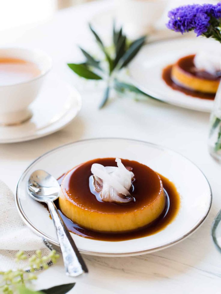 a plate with some food on top of it next to a cup and saucer