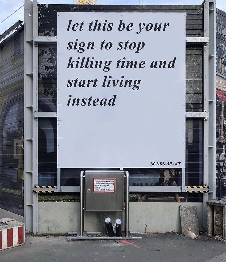 a billboard on the side of a building that says let this be your sign to stop killing time and start living instead