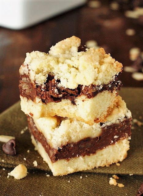 three pieces of chocolate chip cookie bars stacked on top of each other