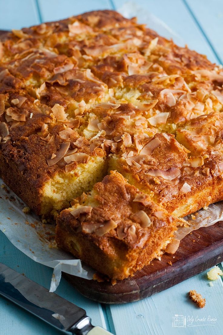 a close up of a cake on a pan with a knife and fork next to it