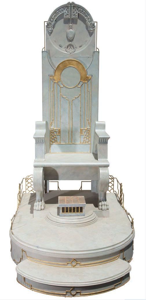 an elaborate white and gold chair on top of a platform with two steps leading up to it