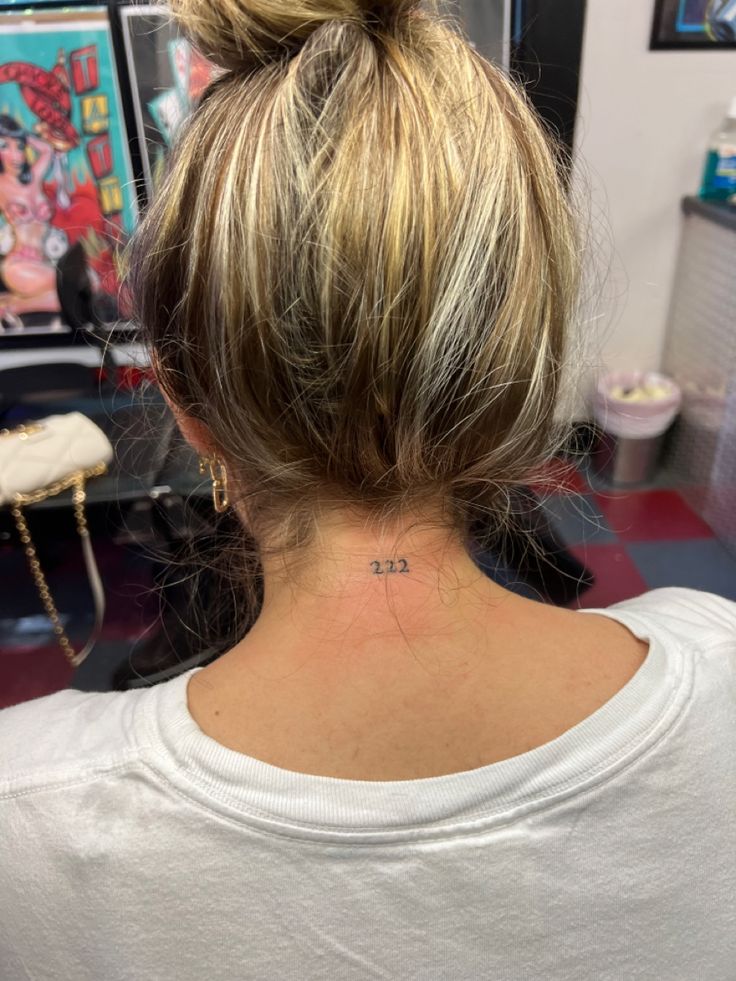 a woman with a small tattoo on her neck