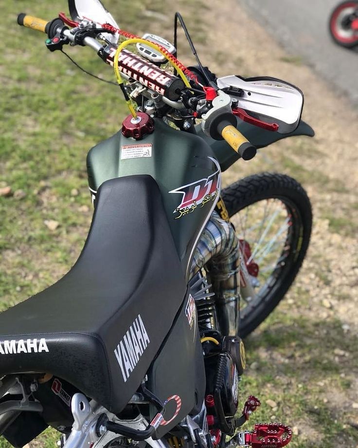 a motorcycle parked on top of a grass covered field