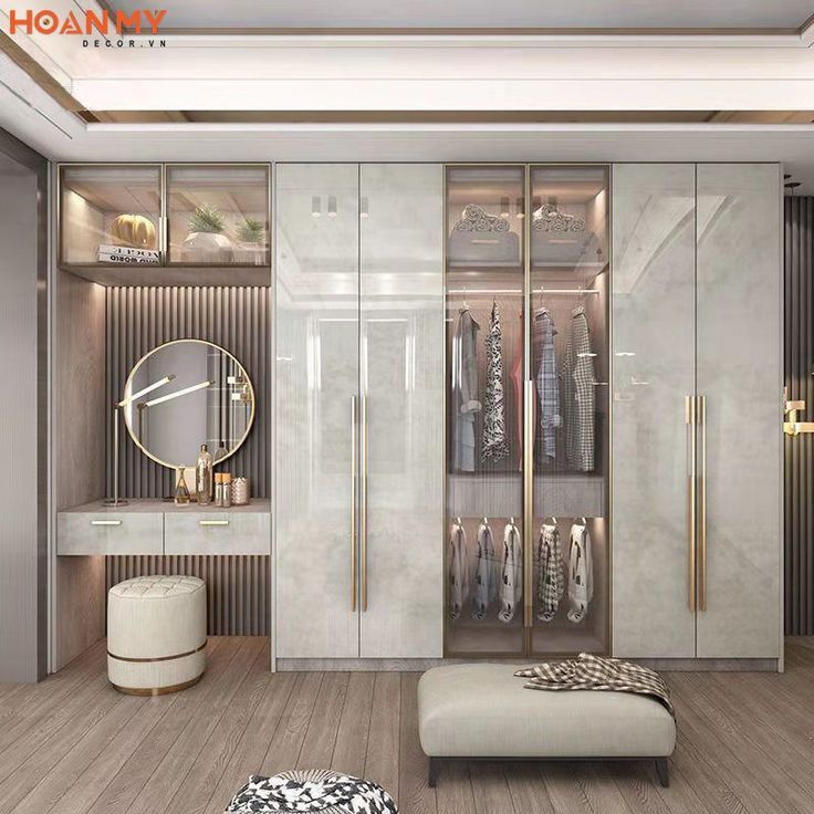 a walk in closet with white walls and wooden flooring, an ottoman on the side