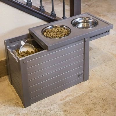 an elevated dog food station with two bowls on top