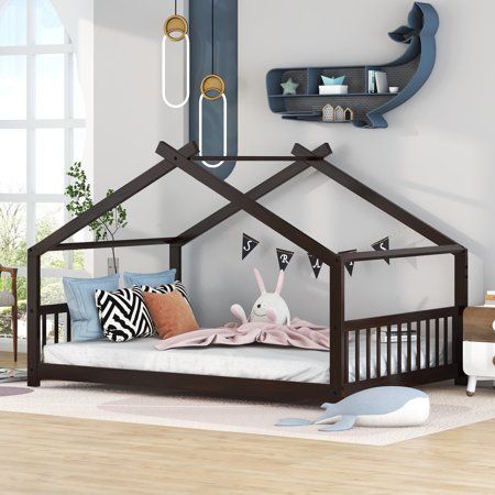 a child's bed with a wooden frame and an animal decoration on the wall