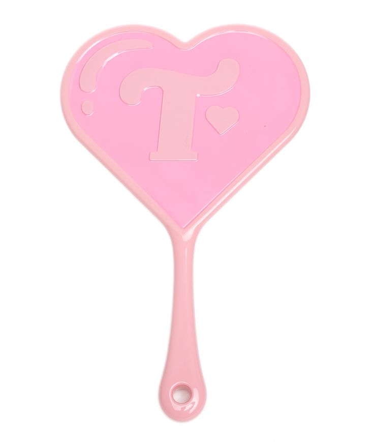 a pink heart shaped spatula with the letter t on it