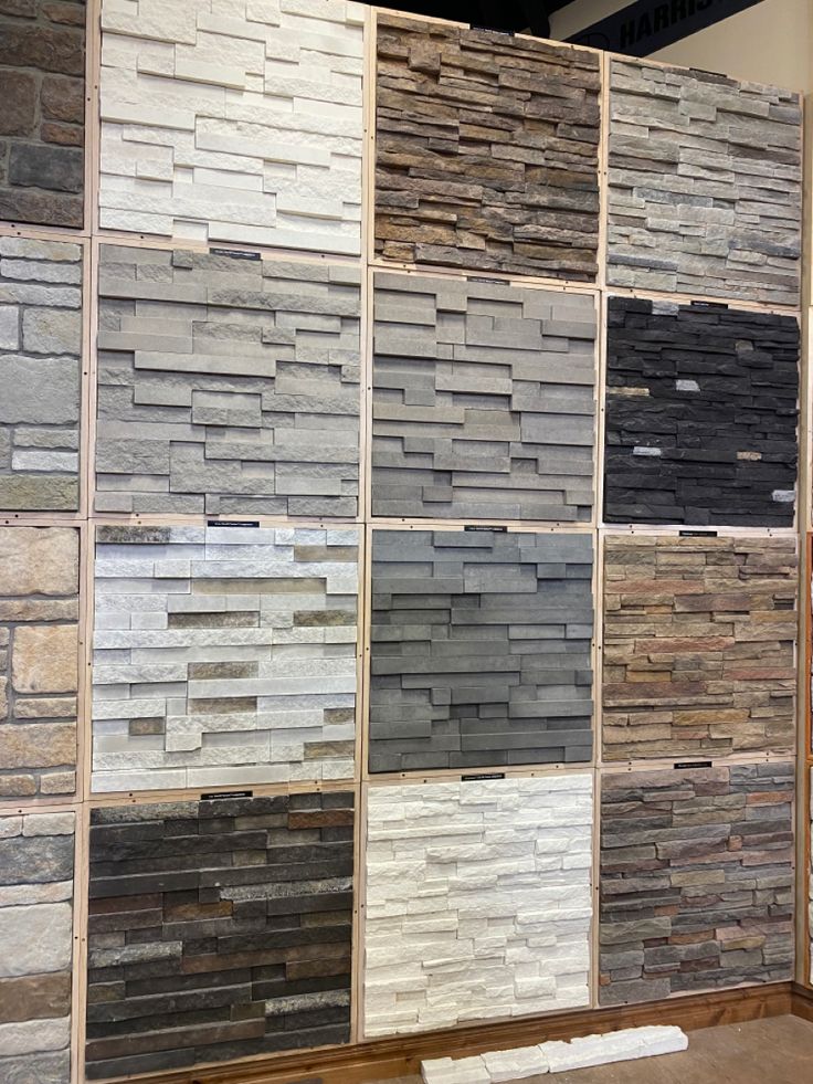 several different types of tile on display in a room with wood flooring and walls