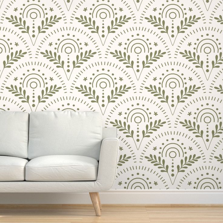 a white couch sitting in front of a wall with a pattern on it's side