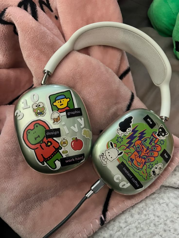 two headphones with cartoon stickers on them