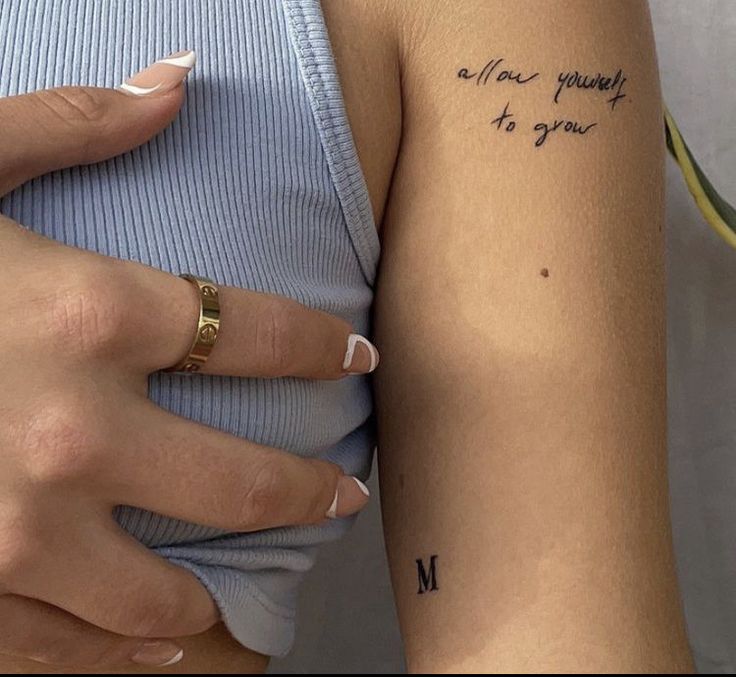 a woman's left arm with a tattoo on it that says, all i need is money to grow