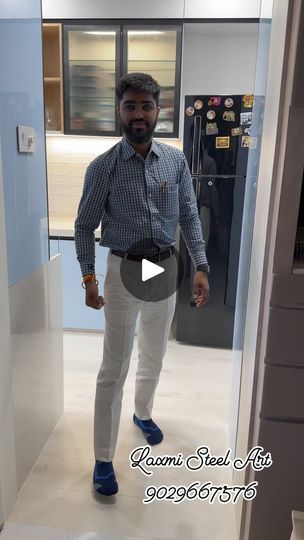 a man is standing in an office hallway