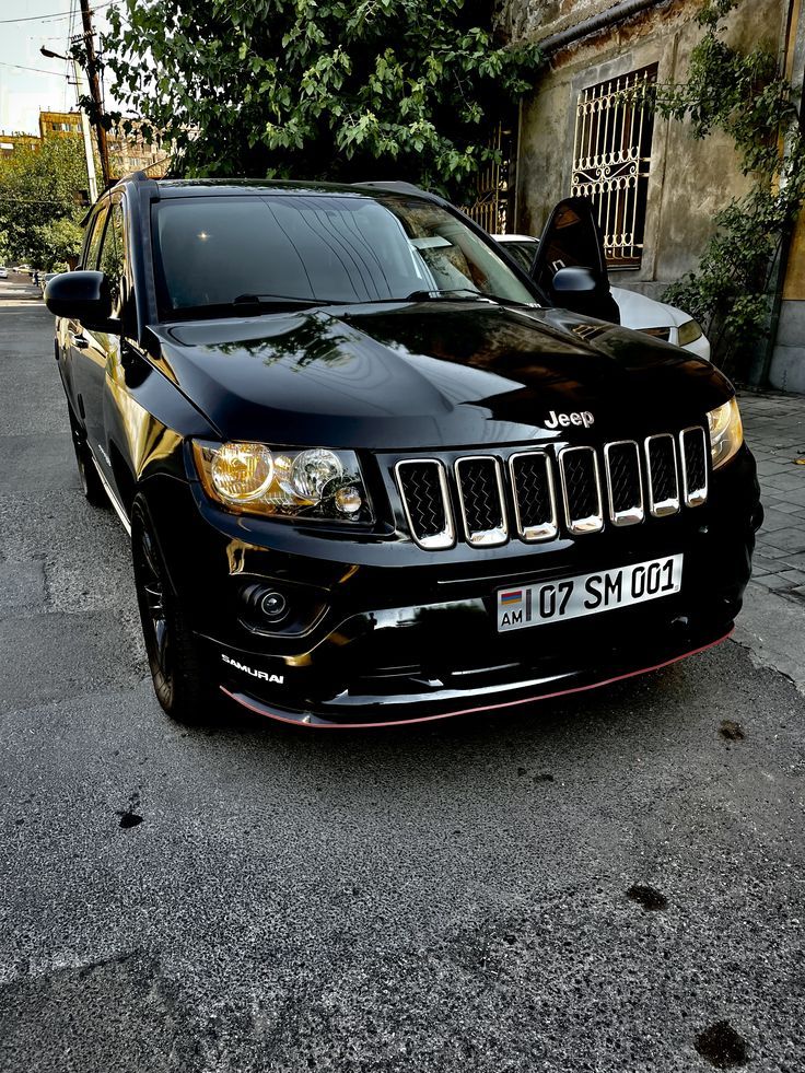 a black jeep is parked on the street