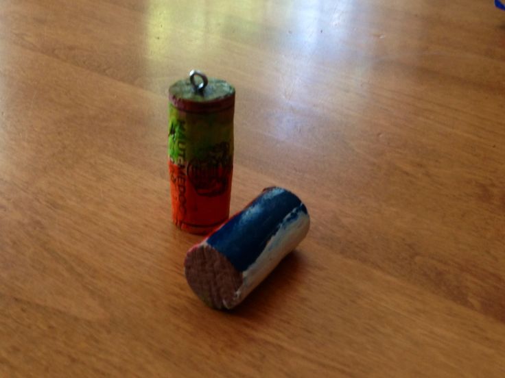 two batteries sitting on top of a wooden floor next to a canister with the lid open