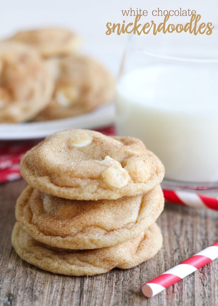 white chocolate snickkers are stacked on top of each other next to a glass of milk