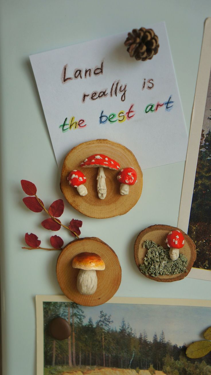 there are three mushrooms on the table and one has a sign that says land really is the best art