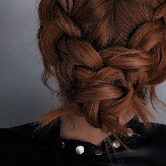 a woman with red hair in a braid