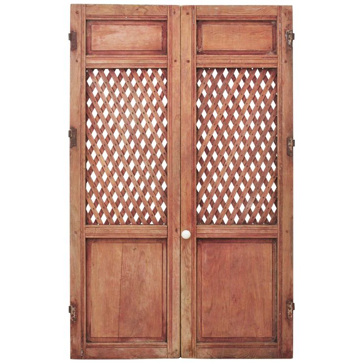 two wooden doors with lattice designs on them