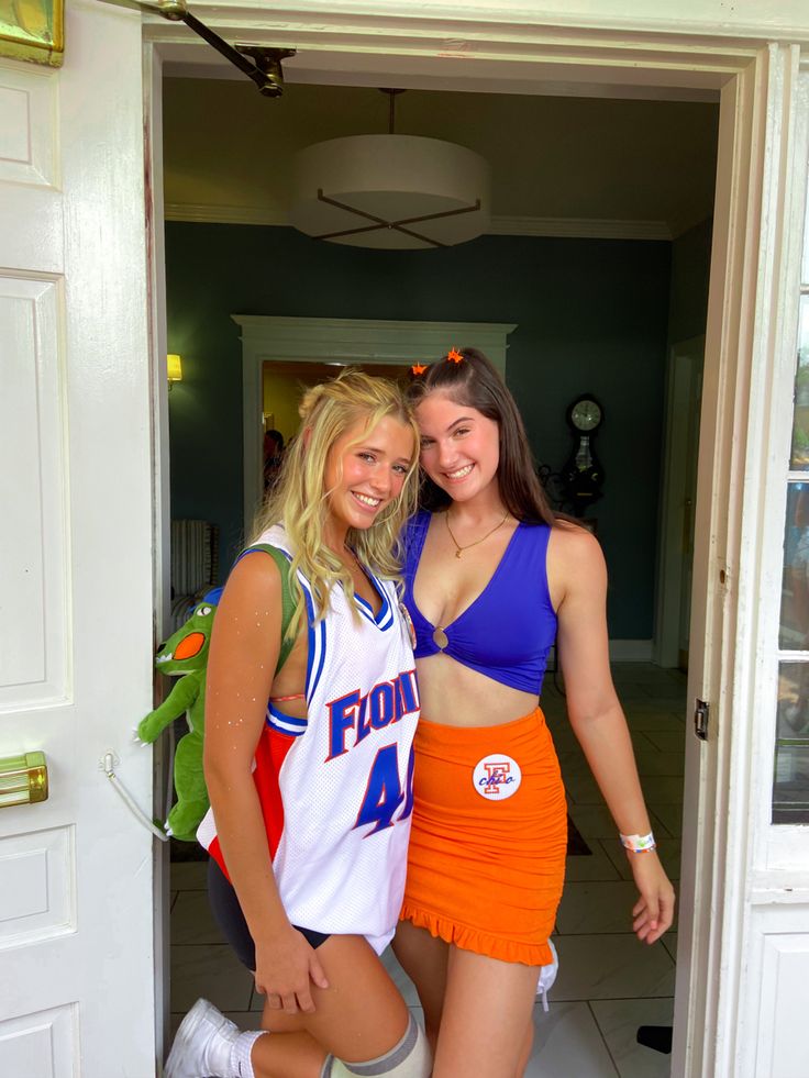 two girls in cheer outfits posing for the camera