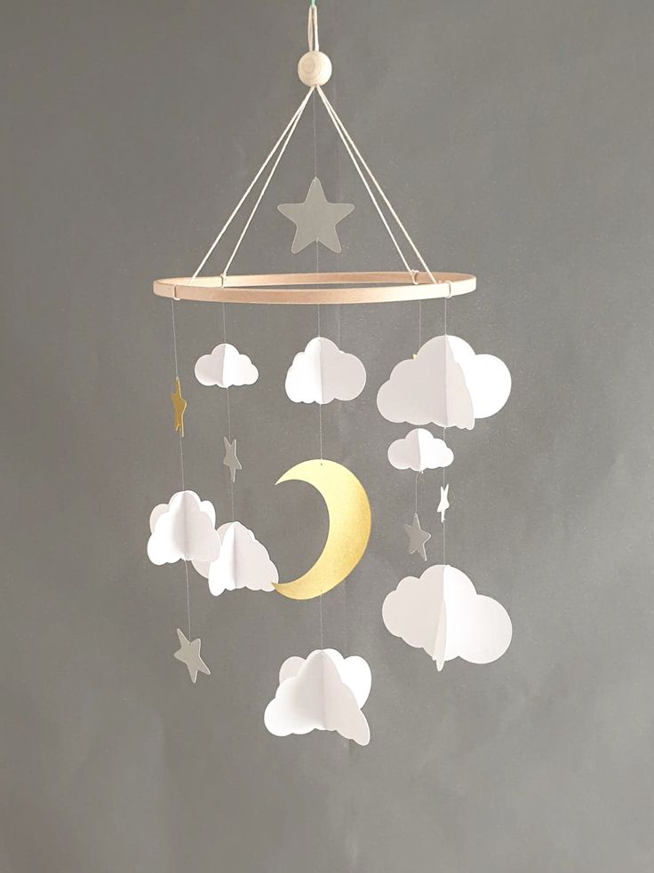 a mobile with stars and clouds hanging from it