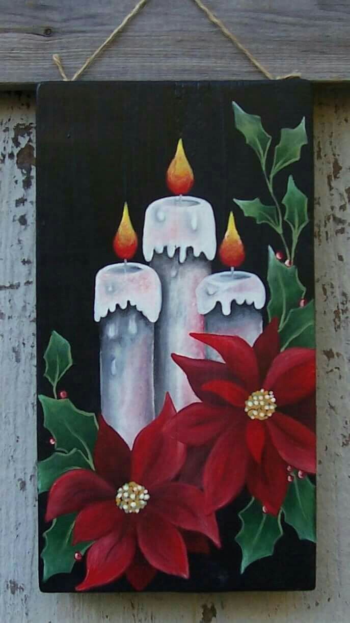 a painting of two candles with poinsettis on a black background hanging on a wall