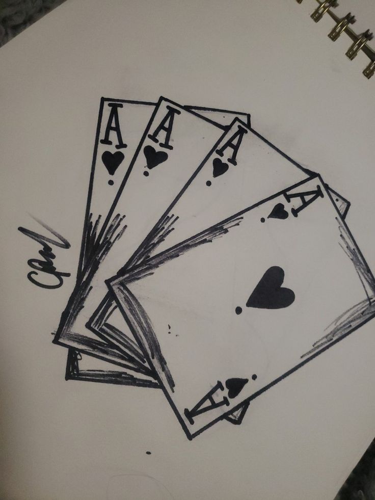 four playing cards are drawn on top of a piece of paper with the word love