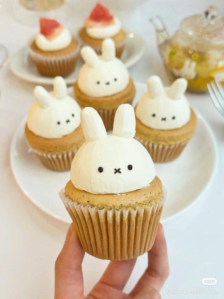 cupcakes with white frosting decorated like bunnies