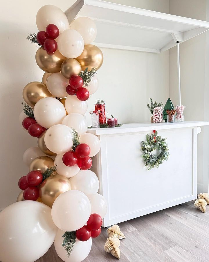 a bunch of balloons that are on top of a table in front of a dresser