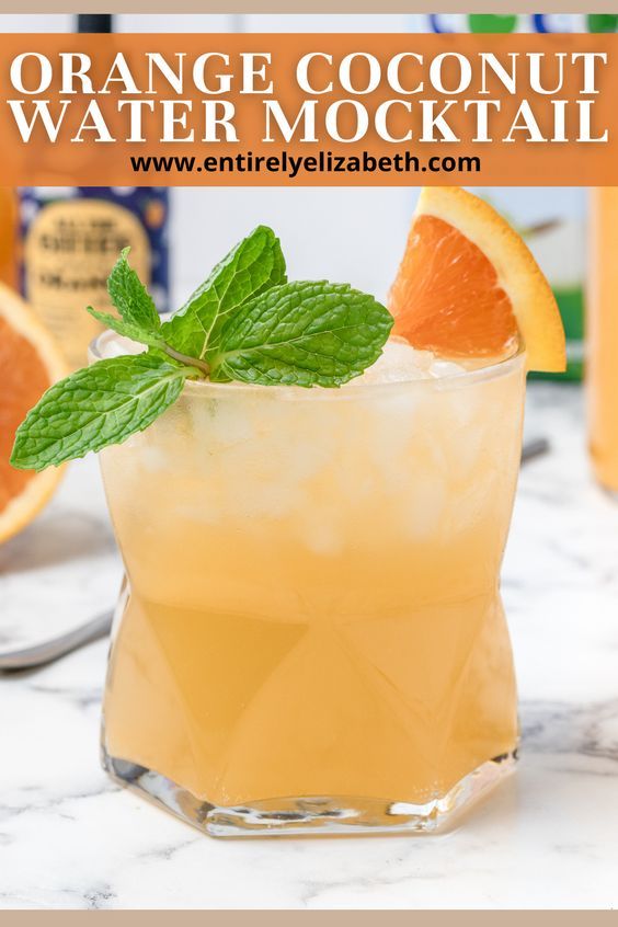 orange coconut water mocko cocktail with mint garnish on the rim and an orange slice