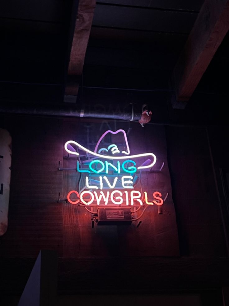 a neon sign that reads lone live cowgirls