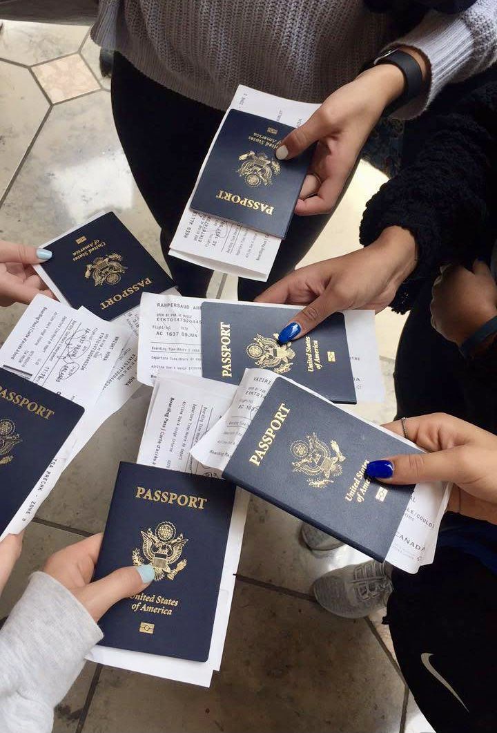 several people holding up their passport cards