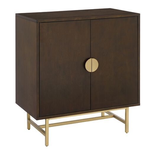 a brown cabinet with gold handles and a round door on the front, against a white background