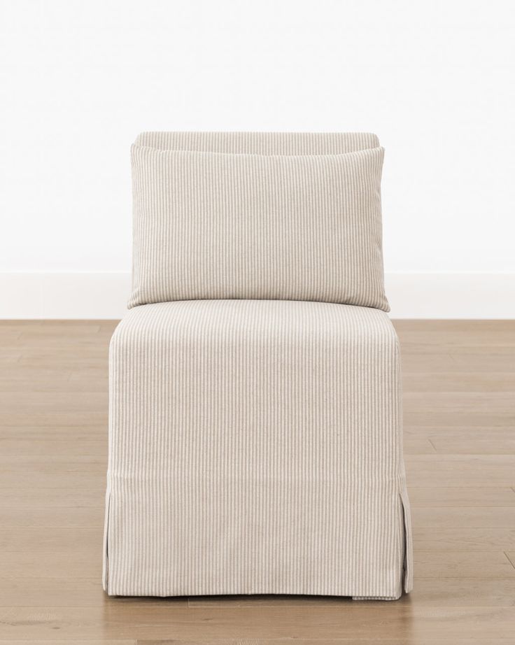 a white chair sitting on top of a hard wood floor