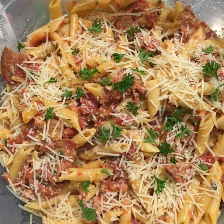 a pasta dish with meat, cheese and parmesan on the top is ready to be eaten