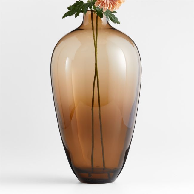 a brown vase with some flowers in it