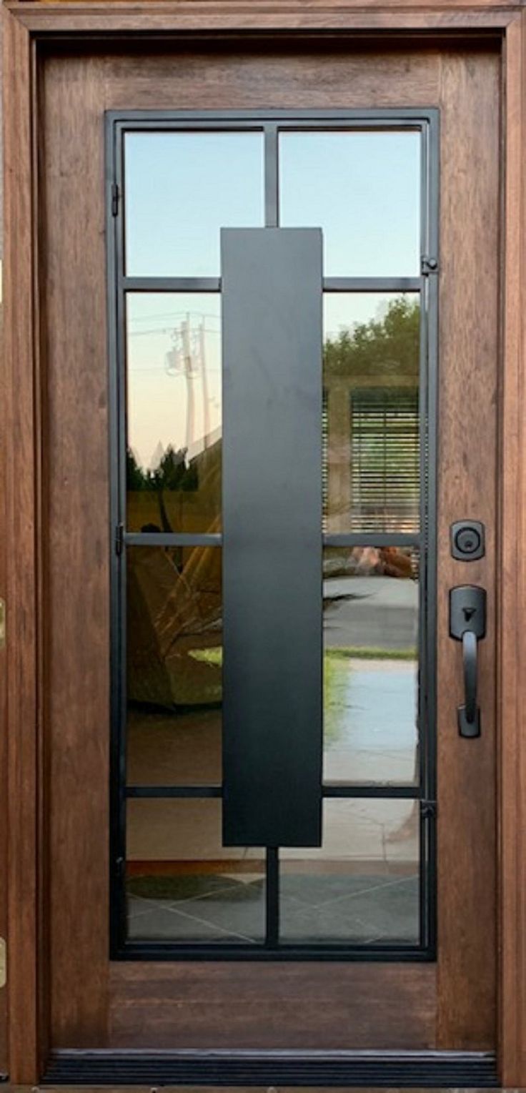 a wooden door with glass and metal handle